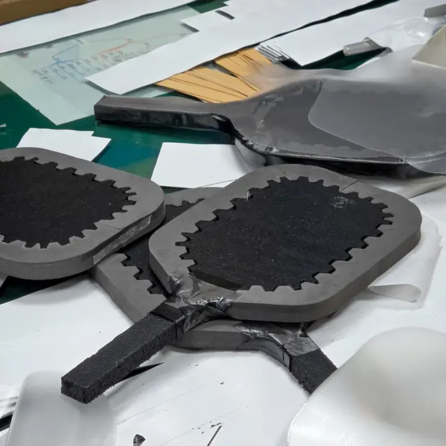 Carbon fiber paddle faces and cores before pressing